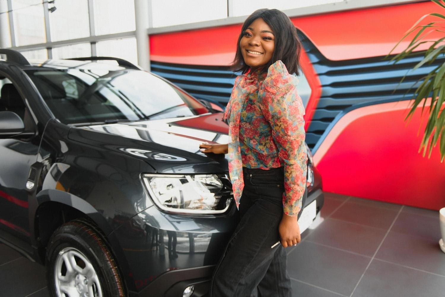 Renter inspecting a black SUV at a car rental office in Dubai before pickup